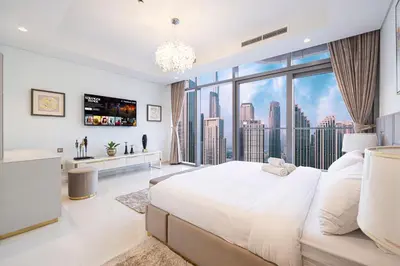 a bedroom with a large bed and a large window at Panoramic Burj Khalifa views-64th floor infinity pool in Dubai