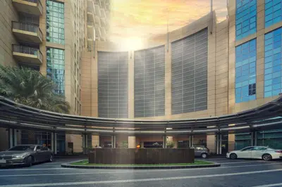 a large building with cars parked in a parking lot at Stunning Luxury Studio Downtown 2 Minute Walk to Burj Khalifa & Dubai Mall in Dubai