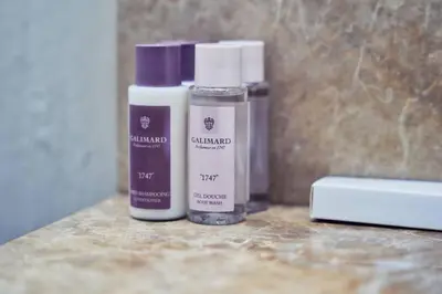 two bottles of essential oils sitting on a counter at Stunning Luxury Studio Downtown 2 Minute Walk to Burj Khalifa & Dubai Mall in Dubai