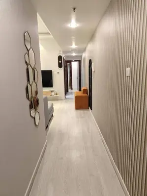 a hallway leading to a living room with a couch at Large 1BR with Great View in Dubai