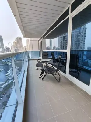 a balcony with a table and chairs on a building at Large 1BR with Great View in Dubai
