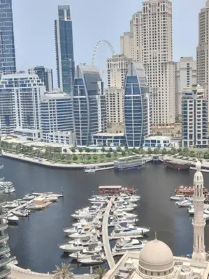 a group of boats parked in a harbor in a city at Large 1BR with Great View in Dubai