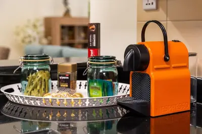 an orange toaster sitting on a counter with a tray of food at Luxury 1 bedroom apartment in JBR with Beach access in Dubai