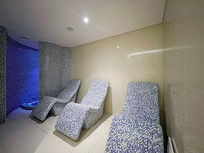 three chairs in a room with blue and white patterns at Stylish Studio in Heart Downtown Next Dubai Mall in Dubai