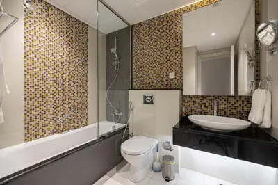 a bathroom with a sink and a toilet and a mirror at Stylish Studio in Heart Downtown Next Dubai Mall in Dubai