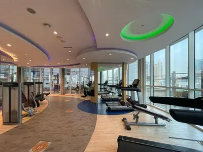a gym with treadmills and ellipticals in a building at Stylish Studio in Heart Downtown Next Dubai Mall in Dubai