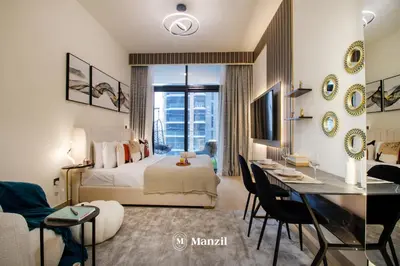a hotel room with a bed and a desk and a room at Manzil - Studio Apartment in Azizi Riviera near Dubai Mall in Dubai
