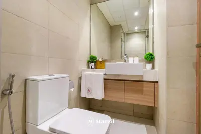 a bathroom with a toilet and a sink and a mirror at Manzil - Studio Apartment in Azizi Riviera near Dubai Mall in Dubai