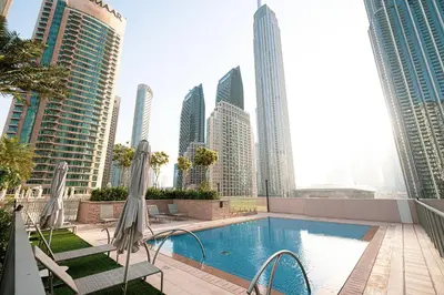 a pool in the middle of a city with tall buildings at Kabene Exotic, Burj Khalifa & Fountain View, 5 Starts, 4 Bedroom, Best In Dubai in Dubai