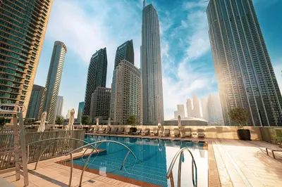 a swimming pool in a city with tall buildings at Kabene Exotic, Burj Khalifa & Fountain View, 5 Starts, 4 Bedroom, Best In Dubai in Dubai