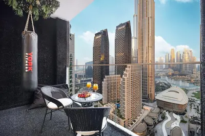 a balcony with a table and chairs and a city skyline at Kabene Exotic, Burj Khalifa & Fountain View, 5 Starts, 4 Bedroom, Best In Dubai in Dubai