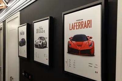 a wall with four framed pictures of a car at Kabene Exotic, Burj Khalifa & Fountain View, 5 Starts, 4 Bedroom, Best In Dubai in Dubai