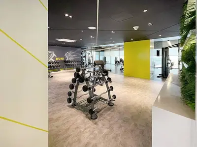 an office with a gym with a chair and weights at FIRST CLASS Studio Luxe Living in Dubai