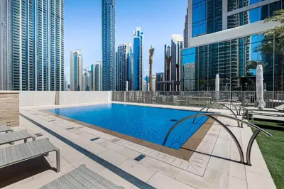 a swimming pool in a city with tall buildings at 1BR Forte II Downtown View in Dubai