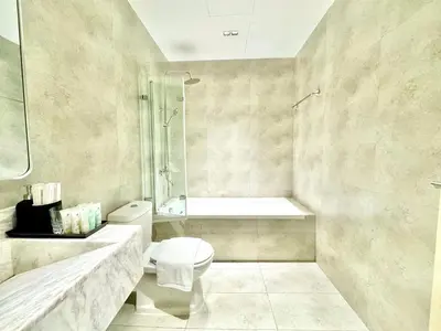 a bathroom with a shower and a toilet and a sink at Urban Oasis Stylish JLT Apartment with Lake Views in Dubai