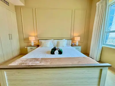 a bedroom with a bed with two stuffed animals on it at Urban Oasis Stylish JLT Apartment with Lake Views in Dubai