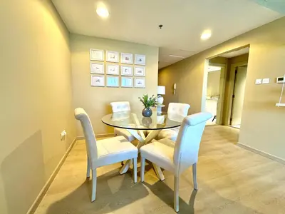 a dining room with a glass table and chairs at Urban Oasis Stylish JLT Apartment with Lake Views in Dubai