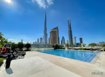 a swimming pool with a city skyline in the background at Charming 1BR Apartment in Downtown Views 1, Downtown Dubai by Deluxe Holiday Homes in Dubai