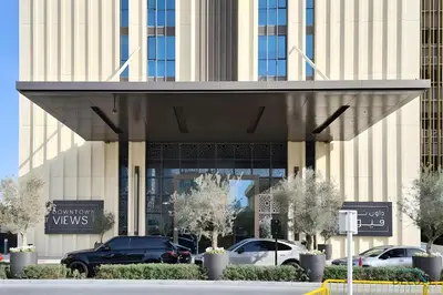 a building with cars parked in front of it at Charming 1BR Apartment in Downtown Views 1, Downtown Dubai by Deluxe Holiday Homes in Dubai