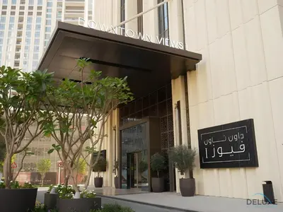 a store front of a building with a sign on it at Charming 1BR Apartment in Downtown Views 1, Downtown Dubai by Deluxe Holiday Homes in Dubai