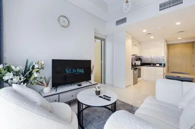 a living room with white furniture and a flat screen tv at ALiving Charming 1BR I Aykon City Tower, Business Bay in Dubai
