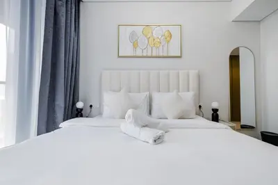 a white bedroom with a large white bed at ALiving Charming 1BR I Aykon City Tower, Business Bay in Dubai