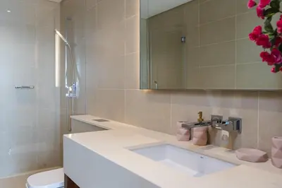 a bathroom with a sink and a toilet and a mirror at Stunning 1Bed High Floor Marina View in Dubai