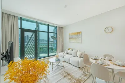 a living room with a white couch and a table at Beach access I Sea View I Infinity pool in Dubai
