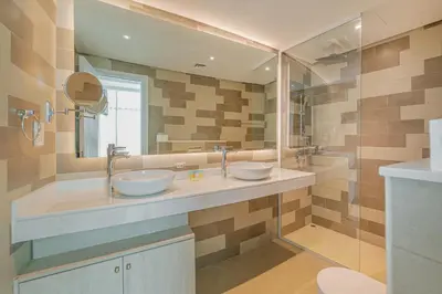 a bathroom with two sinks and a large mirror at Beach access I Sea View I Infinity pool in Dubai
