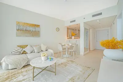 a white living room with a couch and a table at Beach access I Sea View I Infinity pool in Dubai