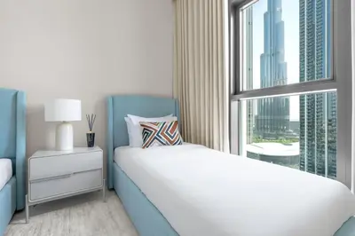 a bedroom with a bed and a large window at Stunning 3 Bedroom Apartment with Fountain Views by ZEN STAYS - Sleeps 9 - 2 Balconies in Dubai
