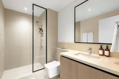 a bathroom with a shower and a toilet and a sink at Stunning 3 Bedroom Apartment with Fountain Views by ZEN STAYS - Sleeps 9 - 2 Balconies in Dubai