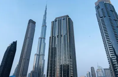 a group of tall buildings in a city at Stunning 3 Bedroom Apartment with Fountain Views by ZEN STAYS - Sleeps 9 - 2 Balconies in Dubai