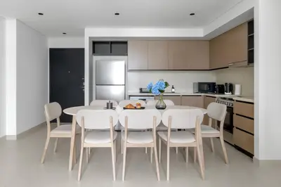 a dining room with a table and chairs in a kitchen at Stunning 3 Bedroom Apartment with Fountain Views by ZEN STAYS - Sleeps 9 - 2 Balconies in Dubai