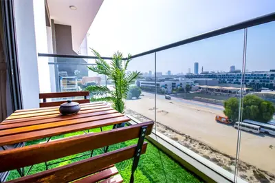 a balcony with a wooden bench and a view of a city at Sky View, Furnished, FreeParking in Dubai