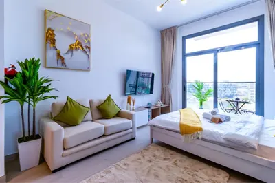 a living room with a couch and a window at Sky View, Furnished, FreeParking in Dubai