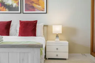 a bedroom with a bed and a lamp on a night stand at Sky Haven in 45th Floor 2BR with Dubai Harbour Views in Dubai