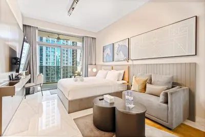 a hotel room with a bed and a couch at MAG318 Downtown Luxury - 5 Min Walk to Burj & Mall in Dubai