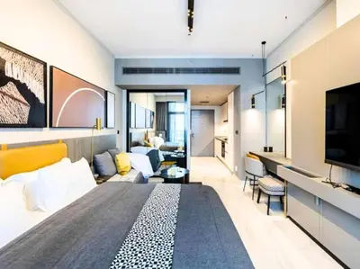 a bedroom with a large bed and a living room at MAG318 Downtown Luxury - 5 Min Walk to Burj & Mall in Dubai