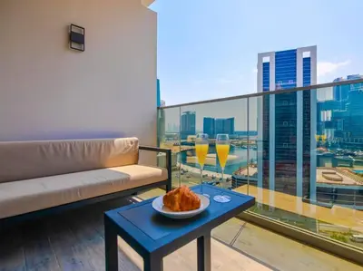 a living room with a couch and a table with wine glasses at MAG318 Downtown Luxury - 5 Min Walk to Burj & Mall in Dubai