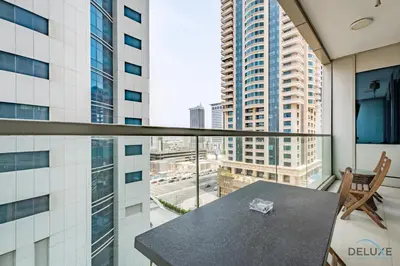 a balcony with a table and a view of a city at Charming 1BR Apartment at Ocean Heights Dubai Marina by Deluxe Holiday Homes in Dubai