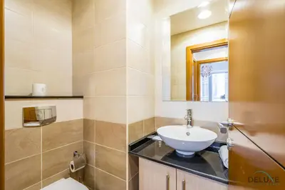 a bathroom with a sink and a mirror at Charming 1BR Apartment at Ocean Heights Dubai Marina by Deluxe Holiday Homes in Dubai