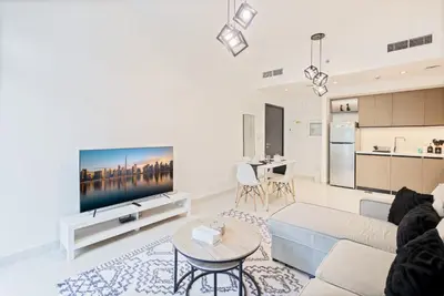 a living room with a couch and a tv at Downtown Apartments - Burj Crown - 5 Min Walk to Mall in Dubai