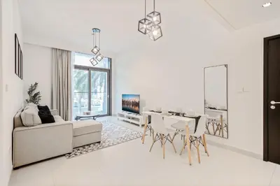 a white living room with a couch and a table at Downtown Apartments - Burj Crown - 5 Min Walk to Mall in Dubai
