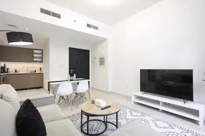 a living room with a couch and a tv and a table at Downtown Apartments - Burj Crown - 5 Min Walk to Mall in Dubai