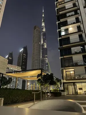 a view of the burj khalifa from a city at night at Downtown Apartments - Burj Crown - 5 Min Walk to Mall in Dubai