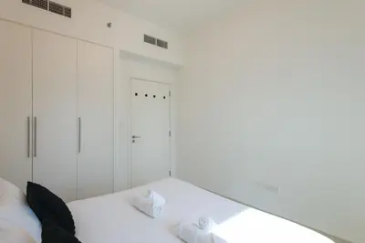 a bedroom with a white bed with two pillows at Sea & City Views - Burj Crown - 5 Min Walk to Mall in Dubai
