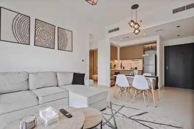 a living room with a couch and a table at Sea & City Views - Burj Crown - 5 Min Walk to Mall in Dubai