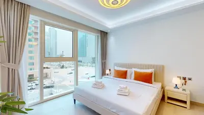 a bedroom with a bed and a large window at Primestay - Elevated Studio in JLT - Dubai in Dubai