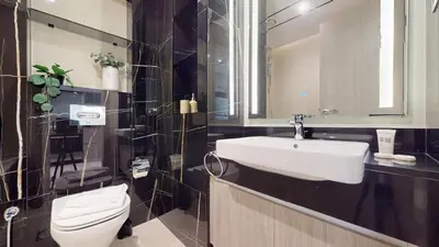 a bathroom with a white sink and a toilet at Primestay - Elevated Studio in JLT - Dubai in Dubai